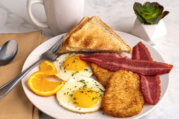 fried eggs  with turkey bacon  and hash browns