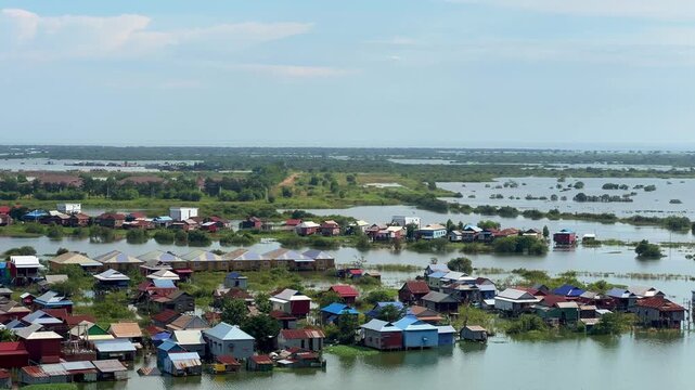 Viewpoint of a flooded fishing village near the Krahom Temple, Cambodia. From the mountain Krahom (Pnom Krom) overlooking the lake Tonlesap. Houses are built on high stilts. Rainy season. 4К