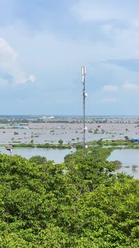 Viewpoint of a flooded fishing village near the Krahom Temple, Cambodia. From the mountain Krahom (Pnom Krom) overlooking the lake Tonlesap. Houses are built on high stilts. Rainy season. 4К