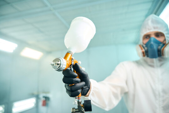 Auto mechanic car man worker working painting in car paint chamber