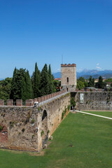 part of the city walls the lions gate and the torre santa maria at pisa tuscany italy sunny summer day no people