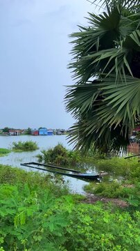 Viewpoint of a flooded fishing village near the Krahom Temple, Cambodia. From the mountain Krahom (Pnom Krom) overlooking the lake Tonlesap. Houses are built on high stilts. Rainy season. 4К