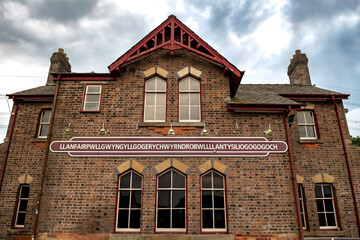Name Plate On Trainstation Building Of Villag Llanfairpwllgwyngyllgogerychwyrndrobwllllantysiliogogogoch in Wales, UK