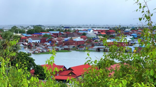 Viewpoint of a flooded fishing village near the Krahom Temple, Cambodia. From the mountain Krahom (Pnom Krom) overlooking the lake Tonlesap. Houses are built on high stilts. Rainy season. 4К