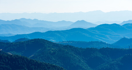 Panoramic view of blue mountain range layers under a clear sky. Mountain scenic nature landscape for peaceful background and travel destination concept in Southeast Asia.