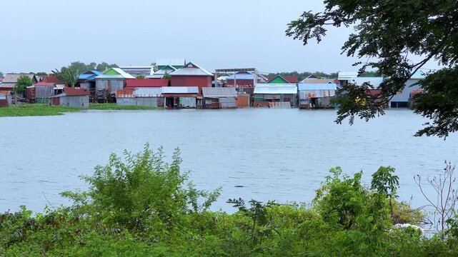 Viewpoint of a flooded fishing village near the Krahom Temple, Cambodia. From the mountain Krahom (Pnom Krom) overlooking the lake Tonlesap. Houses are built on high stilts. Rainy season. 4К