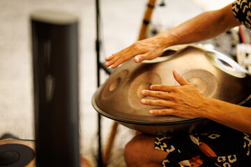 Hands Playing Handpan Drum in Music Session