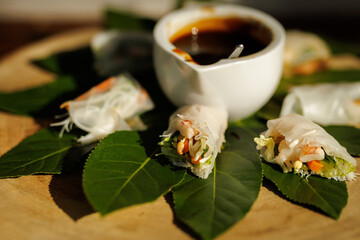 Fresh Spring Rolls with Dipping Sauce on Leaves