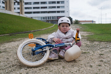 Upset preschool child crying after bicycle accident, concept of childhood injury and safety.