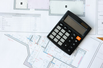 Planning and calculation process using architectural plans and a calculator in a workspace setting