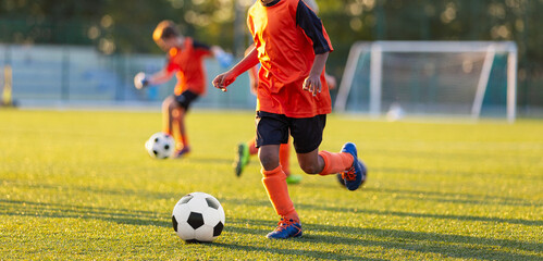 Kids in Soccer Training. Youth Soccer Training Drill. Kids Running With Footballs During Practice Session on Outdoor Grass Field