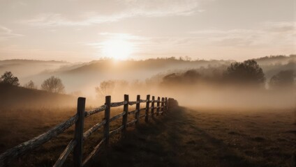 Misty Sunrise Over Rural Landscape with Wooden Fence.