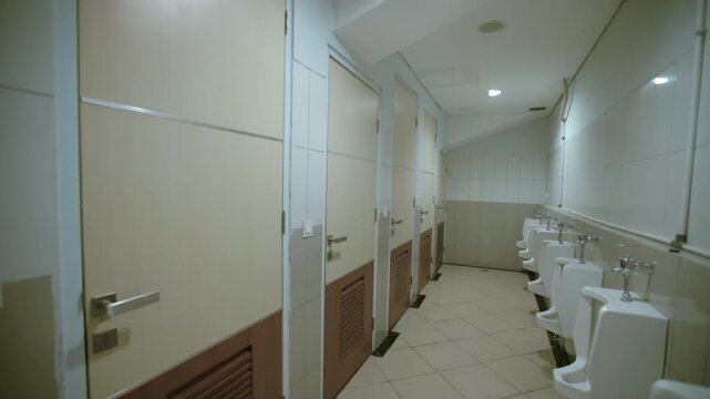 Men's public restroom with urinals and stalls