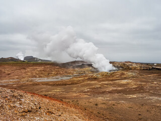 Wooden trail with raised platform in the Gunnuhver Hot Springs. Active geothermal area with volcanic craters, mud pools and steam vents. M&ouml;&eth;ruvellir, M&ouml;&eth;ruvallavegur, Reykjanes Peninsula, Iceland.