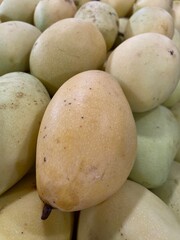 Fresh yellow mangoes for sale at a street market in Indonesia