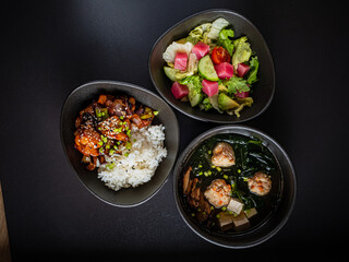 Savor a delightful spread of seasoned chicken, fragrant rice, a crisp salad, and delicate soup