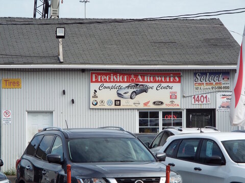 Gloucester, ON, Canada-July 4,2025:A white metal building for "Precision Autoworks" Complete Automotive Centre at 1401 Cyrville Road.
