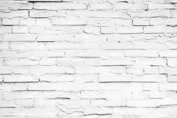 Obraz premium A textured white brick wall with visible cracks and variations in paint, creating a rustic and minimalist aesthetic.