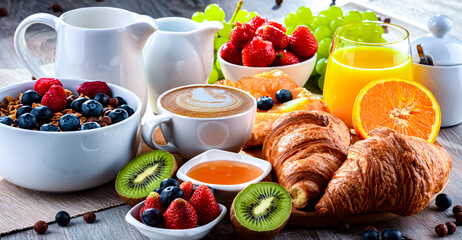 Breakfast served with coffee, juice, croissants and fruits
