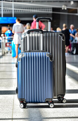 Two plastic travel suitcases in the airport hall