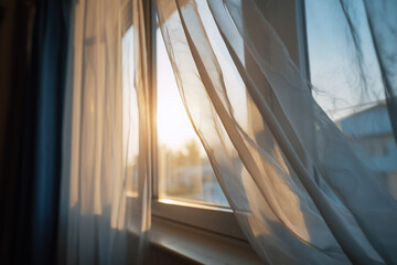 Gentle sunlight filtering through translucent curtains at a window