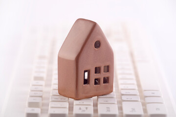 Small house on white computer keyboard