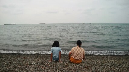 A heartwarming scene of a mother and her young daughter enjoying a joyful day at the beach, perfect for family travel agencies, parenting lifestyle magazines, and sentimental summer-themed advertising