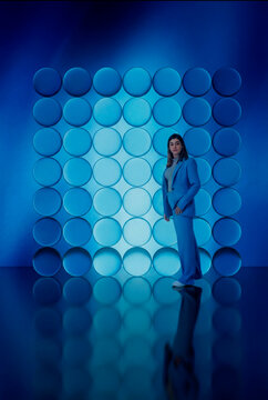 Fashion portrait against blue 3D glass circles backdrop