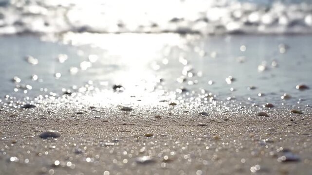Glistening wet sand texture Macro shot of individual sand grains and tiny shell fragments sparkling as a thin sheet of clear water recedes on a pristine summer