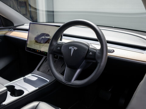 Tesla electric car steering wheel and minimalist cockpit interior