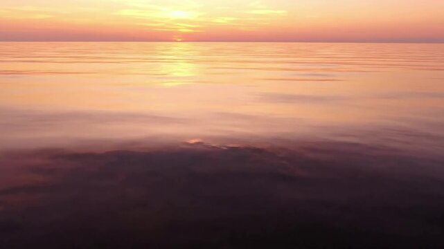 Summer Golden Hour Reflections A wide shot capturing the vast expanse of the ocean mirroring the warm, vibrant colors of the setting summer sun. summer ocean re