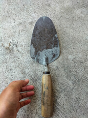 A trowel is a tool commonly used for plastering and plastering walls. Tools building. Selective focus. 

