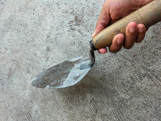 A trowel is a tool commonly used for plastering and plastering walls. Tools building. Selective focus. 
