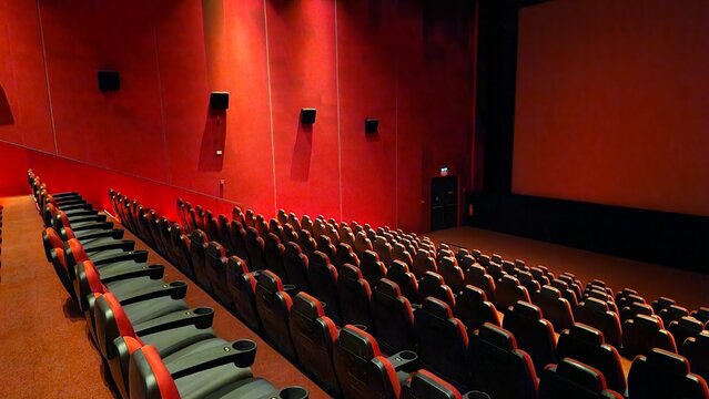 red movie theater, white screen and seats