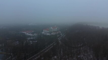 Historic Fuerstenfeld Monastery near Munich. Foggy aerial panorama of the former Cistercian abbey. Featuring the St. Maria church and Baroque architecture amidst a peaceful winter landscape