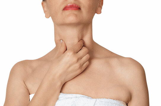 Woman touching her throat and neck, concept of sore throat, thyroid problem, swallowing pain on white