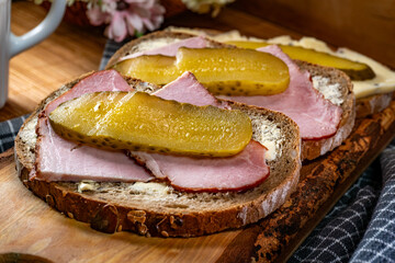 Sandwich with ham, cheese and pickled cucumber.