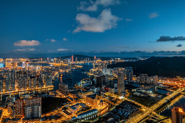 Aerial view of the vibrant city skyline and harbor at night in Macau.