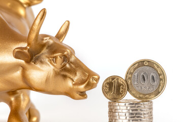A symbol of optimism on the stock exchange, as well as wealth and greed - a golden bull (calf) and coins of 1 and 100 Kazakhstani tenge