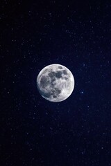 Naklejka premium A bright full moon in a dark, star-filled night sky. Concept Moonlit Night, Starry Sky, Bright Full Moon, Nightscape Photography, Silhouette Under Moonlight