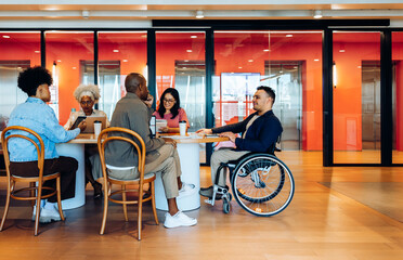 Group meeting at cafe with wheelchair user