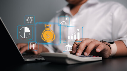 Close up of businessman using calculator and laptop for financial planning with digital money bag and growth icons. Professional male accountant managing budget and investment analysis.