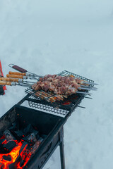 Rustic Cookout With Smoky Aroma, Skewers Roasting Over Glowing Embers In Snowy Outdoor Setting