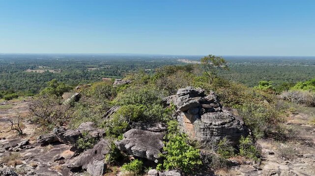Drone aerial footage of Hin Pum stone formations at Phu Pha Phueng viewpoint in Kalasin UNESCO Global Geopark, Thailand, showcasing unique geology, natural landscape, and scenic horizon.