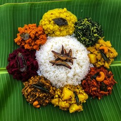 Traditional Sri Lankan rice and curry served on banana leaf, colorful vegetables, authentic local food culture.