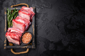 Raw Veal Short Rib, fresh beef meat with bone and herbs for cooking . black background. top view
