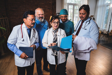 Indian senior surgeons and doctors analyzing medical case file before surgery