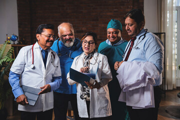 Indian senior surgeons and doctors analyzing medical case file before surgery