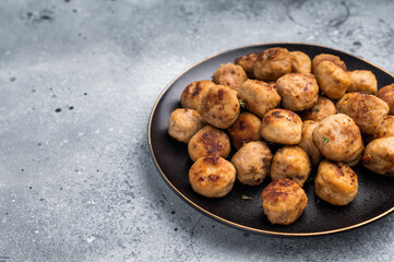 Savory meatballs, meat dumplings garnished with fresh herbs. A delightful addition to any meal, bringing warmth and satisfaction to the table. grey background. top view