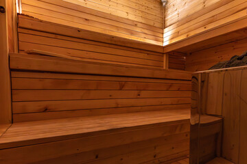 Empty, empty, heated sauna with a Himalayan brick wall, wooden walls in the sauna, Finnish sauna, Himalayan salt, recovery